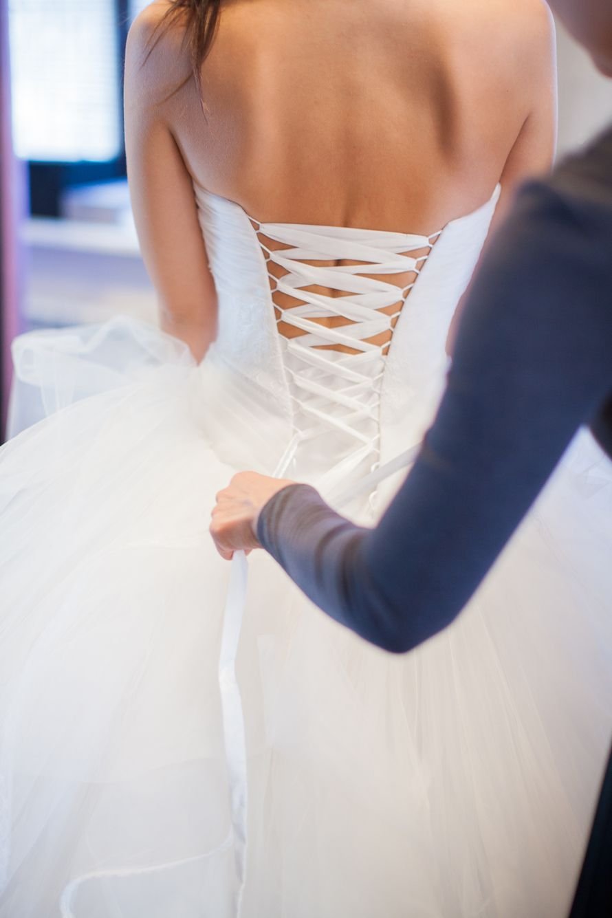 Брюнетка в свадебном платье со спины