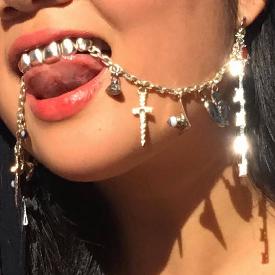 Девушка с цепью в зубах